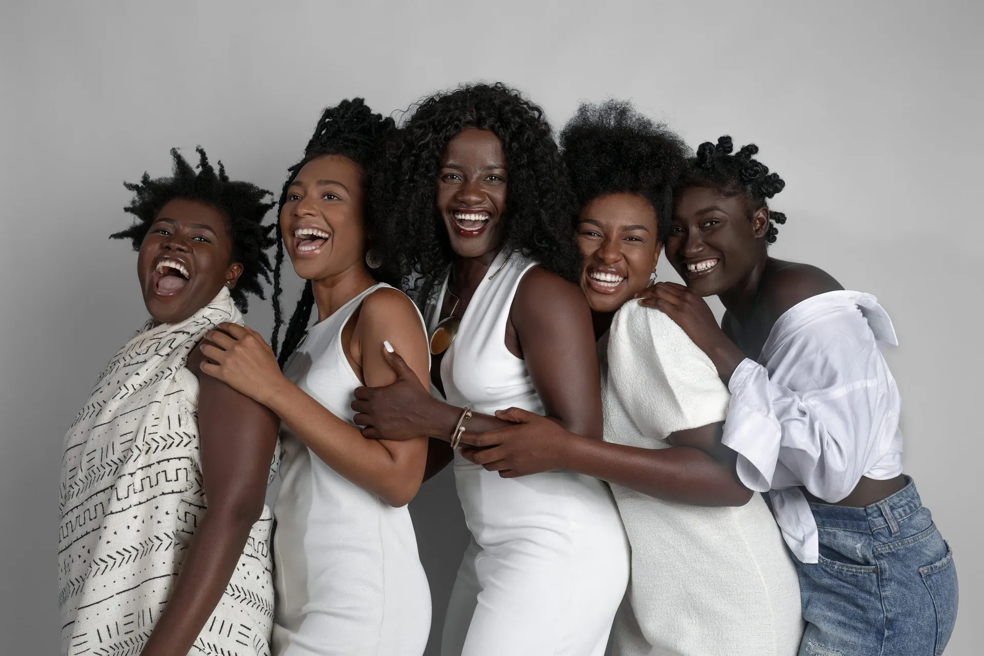 Black women gathered together in a joyful adult community portrait.